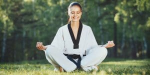 Martial Arts Lessons for Adults in Bossier City LA - Happy Woman Meditated Sitting Background